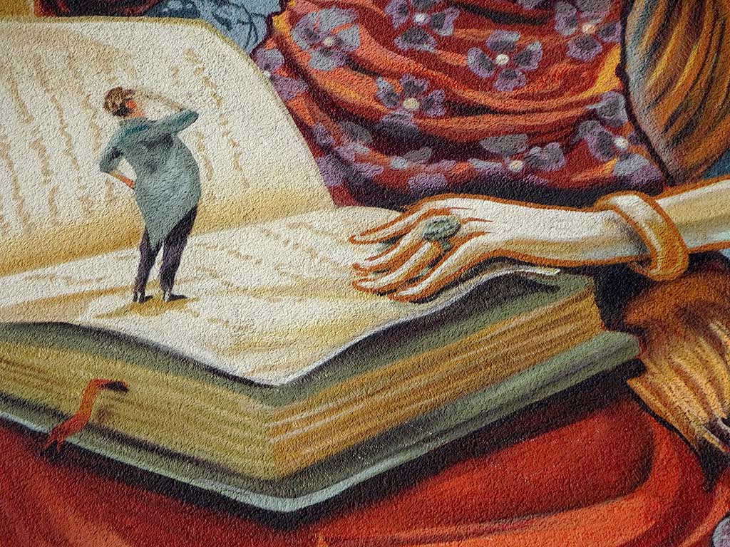 Hausfassadegestaltung zeigt eine Frau mit Buch und Apfel